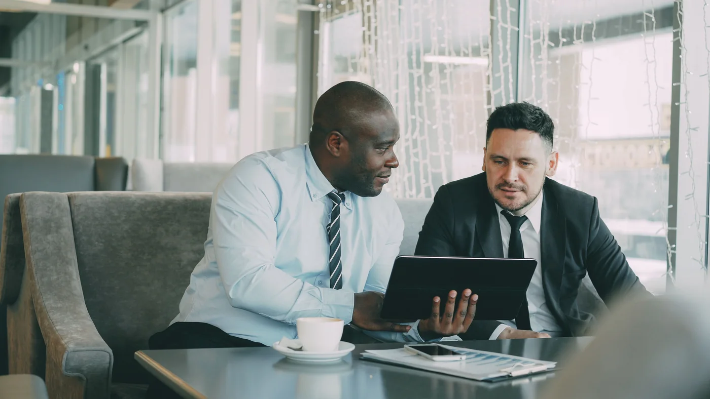 Professionals discussing a decision over a tablet